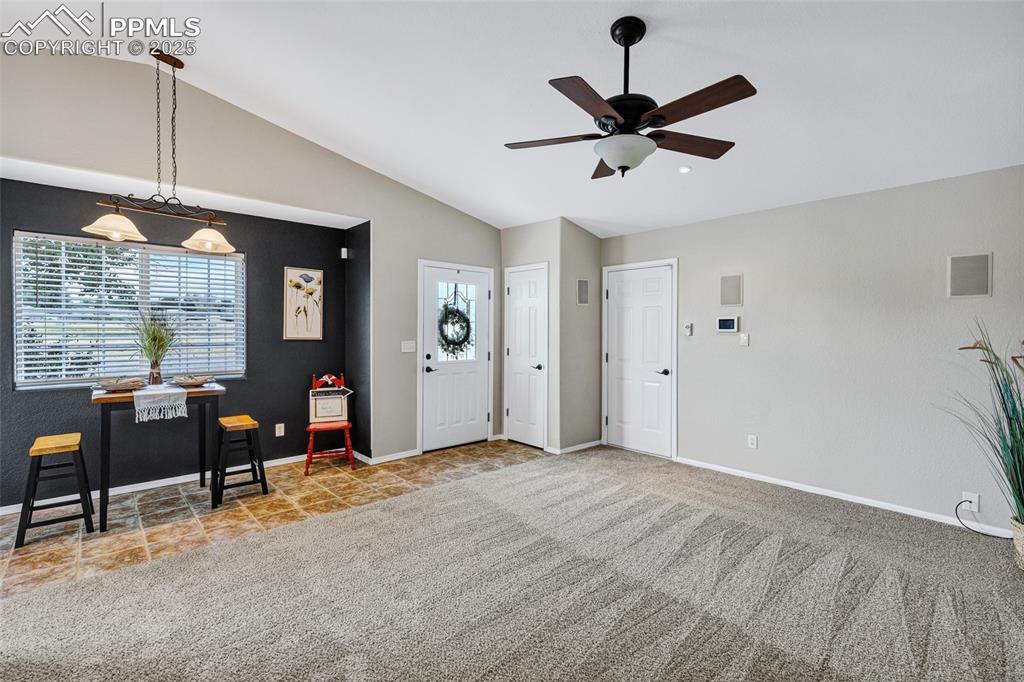 Image 6 of 39: Foyer entrance with plenty of natural light, vaulted ceiling, light carpet,