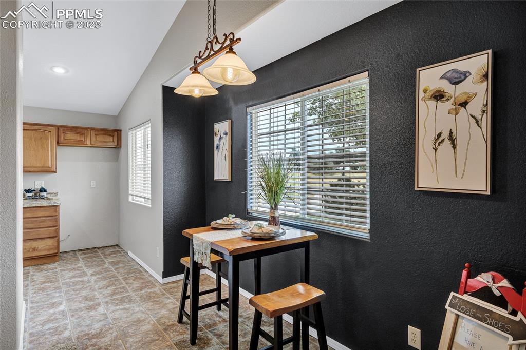 Image 7 of 39: Dining area with a textured wall and baseboards