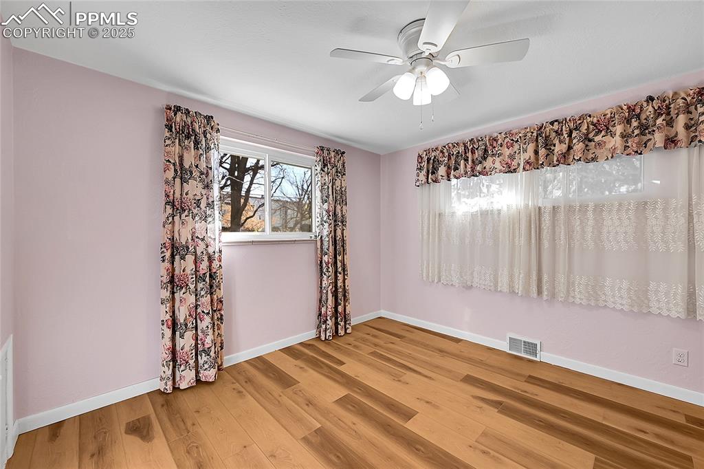 Image 11 of 27: Spare room featuring baseboards and light wood-style floors