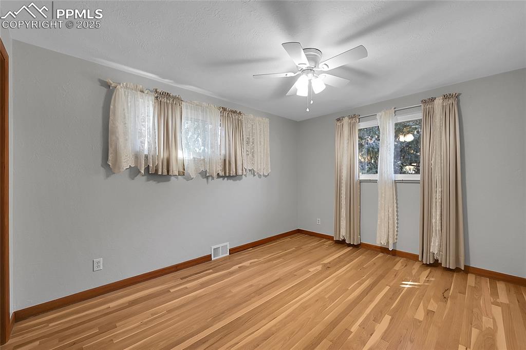 Image 20 of 27: Spare room with light wood-style flooring and a ceiling fan