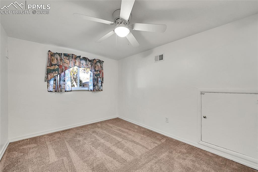 Image 27 of 27: Carpeted empty room featuring baseboards and ceiling fan