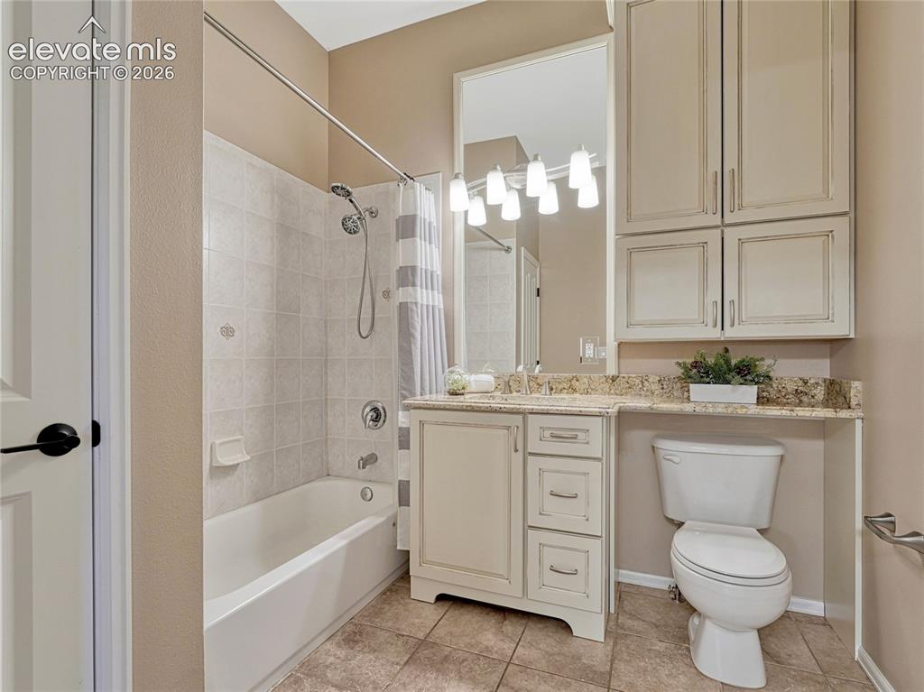 Image 34 of 42: Main Full bath w/tile floor, stone countertops.