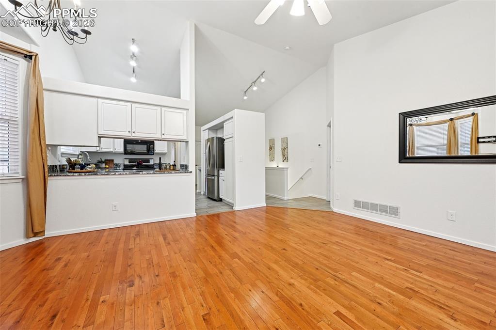 Image 16 of 37: Stairs to basement on other side of kitchen