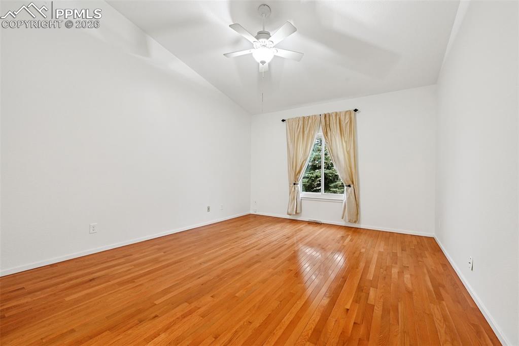 Image 19 of 37: Big primary bedroom with wood floors