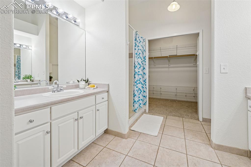 Image 24 of 37: Larger vanity and shower to the left