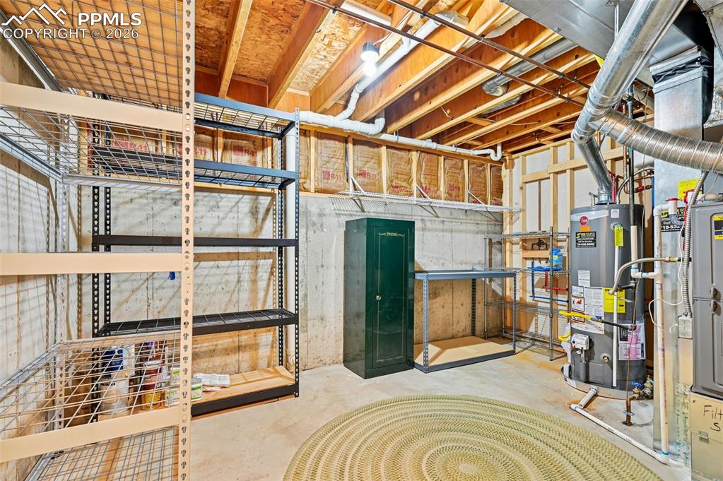 Image 27 of 37: Unfinished utility room, shelving and gun safe stays
