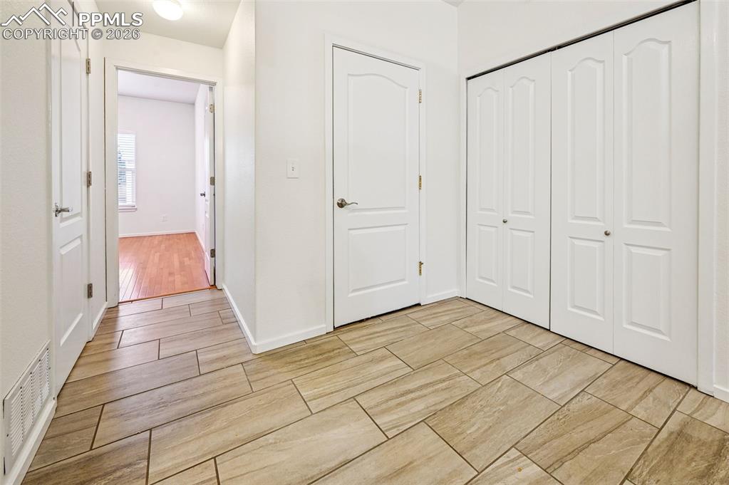 Image 8 of 37: Tile entry  with laundry, garage and bed/bath access