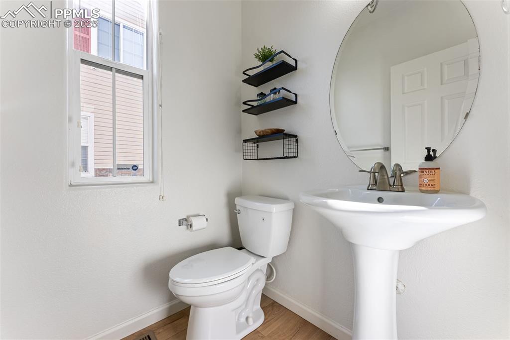 Image 14 of 34: Half bathroom featuring light wood-type flooring and toilet