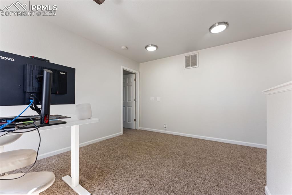 Image 21 of 34: Unfurnished office featuring carpet and baseboards
