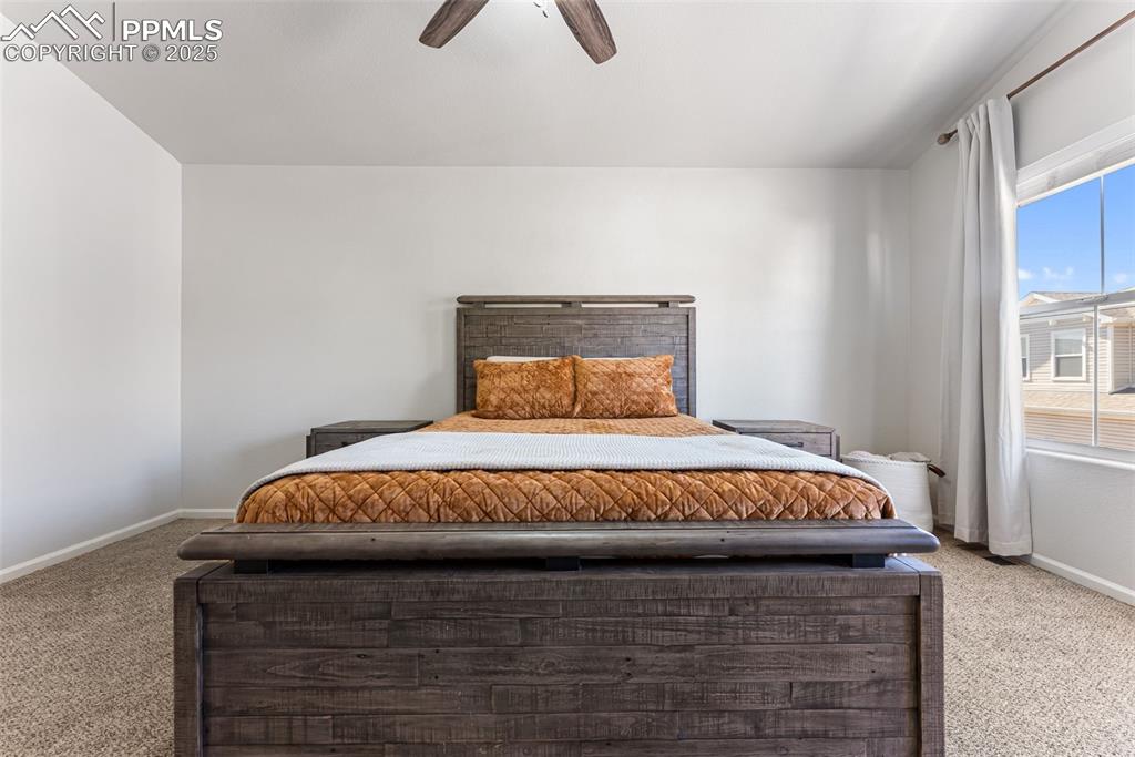 Image 24 of 34: Bedroom with carpet floors and ceiling fan