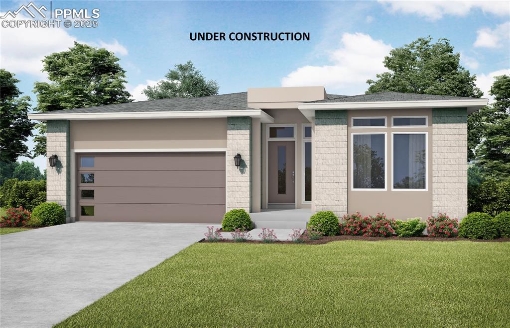 Caption: View of front facade featuring brick siding, an attached garage, a front lawn, and concrete driveway