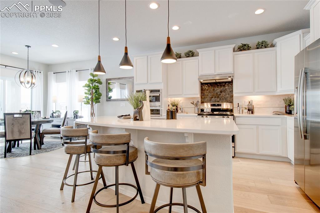 Image 11 of 32: Kitchen with stainless steel appliances, a center island, recessed lighting