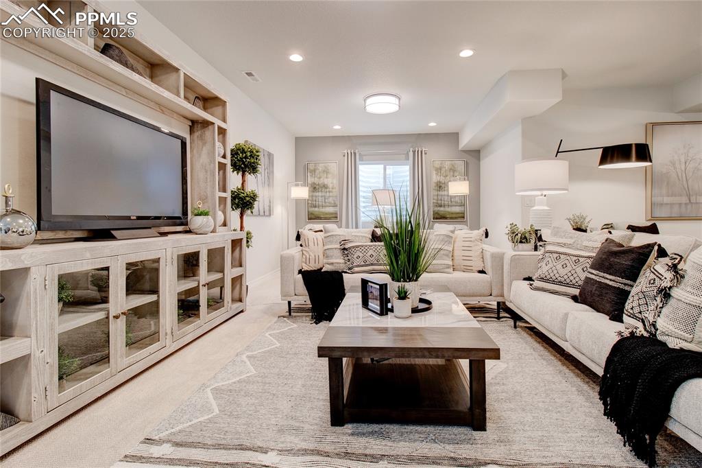 Image 25 of 32: Living area with recessed lighting and visible vents