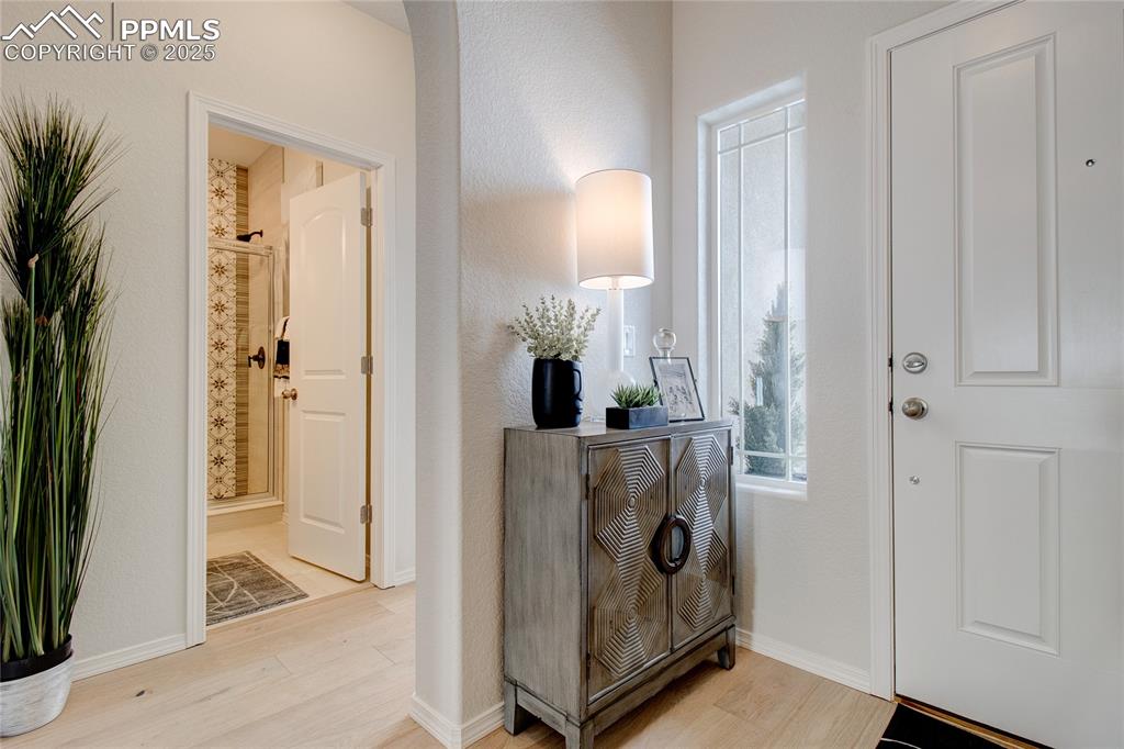 Image 3 of 32: Foyer with baseboards and light wood-type flooring