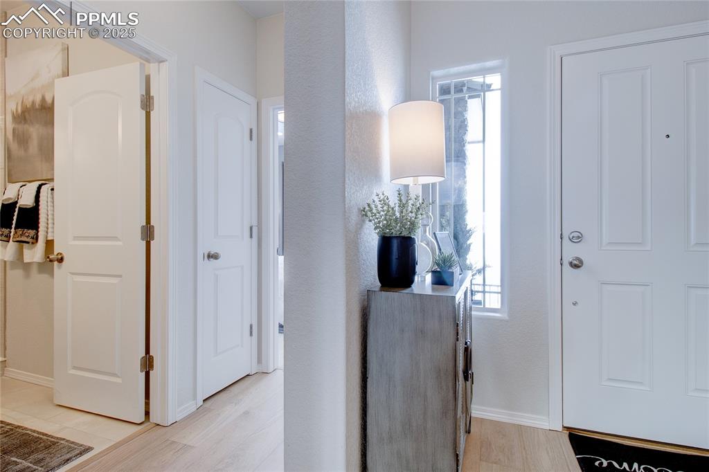 Image 4 of 32: Foyer featuring light wood finished floors and baseboards