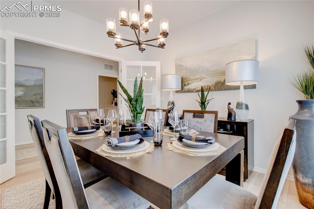 Image 7 of 32: Dining room with baseboards, visible vents, and a chandelier