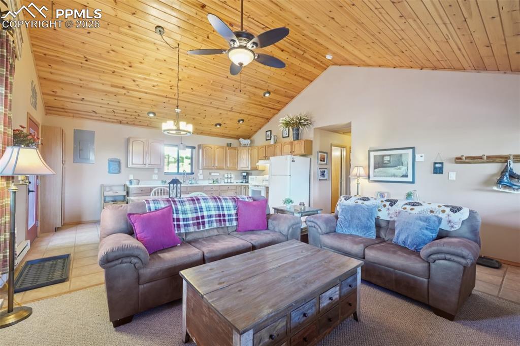 Image 4 of 25: Enter to tile and carpet floors, a charming wood cathedral ceiling with ins