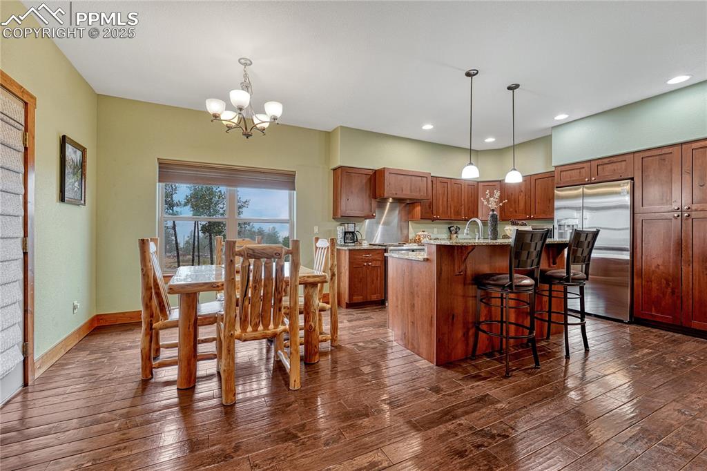 Image 10 of 43: Kitchen featuring stainless steel refrigerator with ice dispenser, a chande