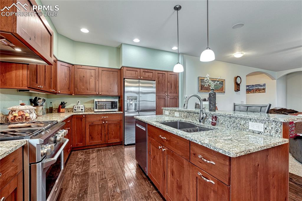 Image 11 of 43: Kitchen featuring stainless steel appliances, a sink, dark wood-style floor