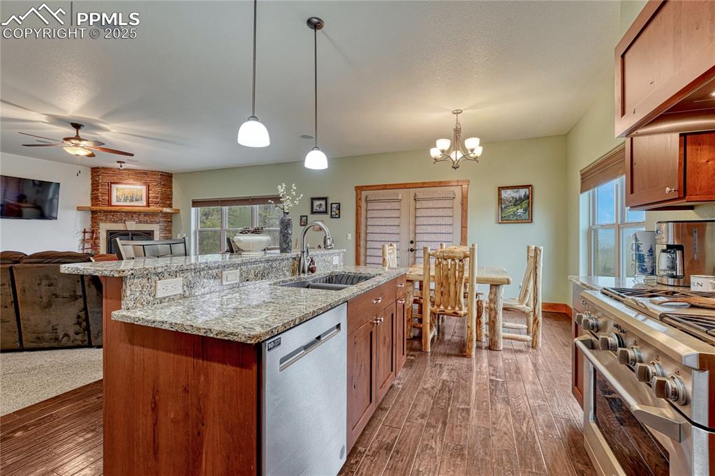 Image 15 of 43: Kitchen with appliances with stainless steel finishes, a sink, ceiling fan,