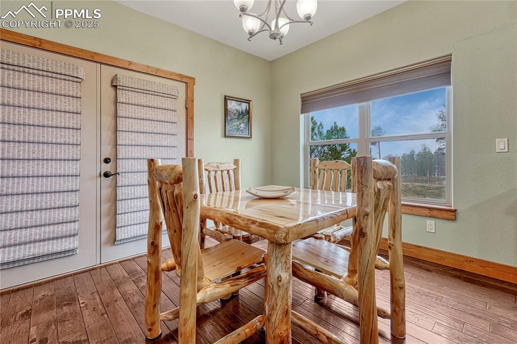 Image 19 of 43: Dining space with a chandelier, hardwood / wood-style flooring, and baseboa
