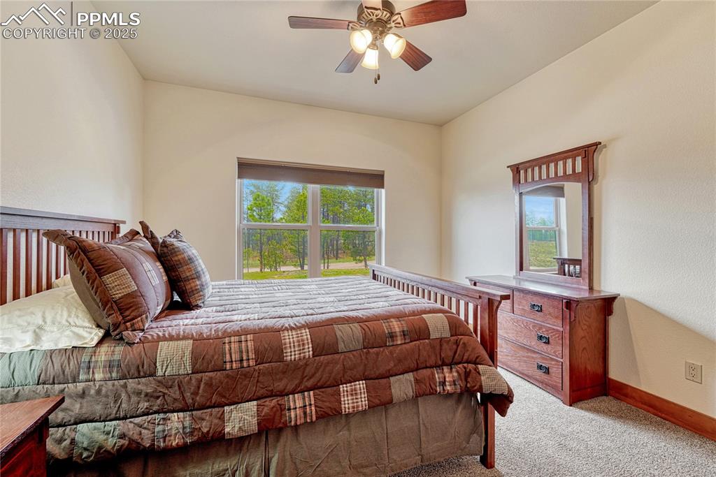 Image 28 of 43: Carpeted bedroom with baseboards and ceiling fan