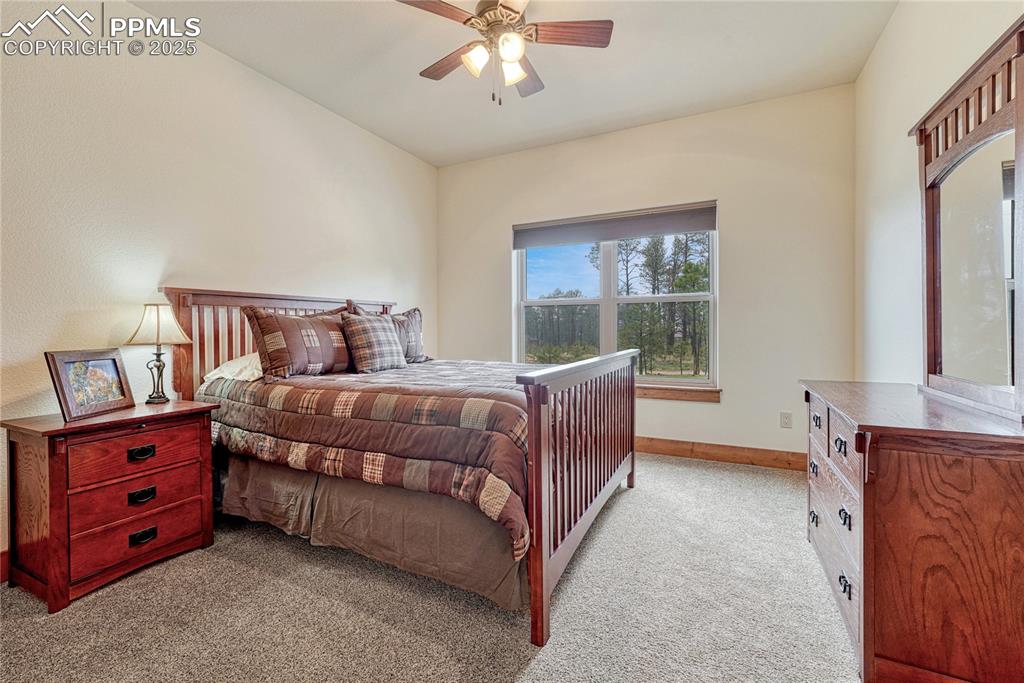 Image 29 of 43: Carpeted bedroom with baseboards and a ceiling fan