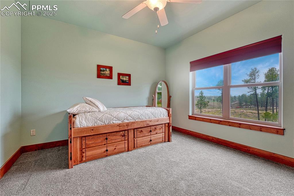 Image 30 of 43: Carpeted bedroom featuring baseboards and ceiling fan