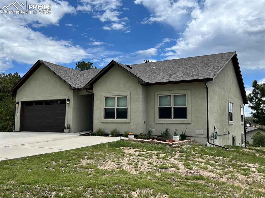 Image 42 of 43: Single story home featuring an attached garage, stucco siding, driveway, an