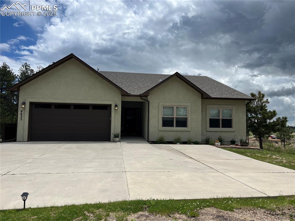 Image 43 of 43: Single story home featuring concrete driveway, an attached garage, stucco s