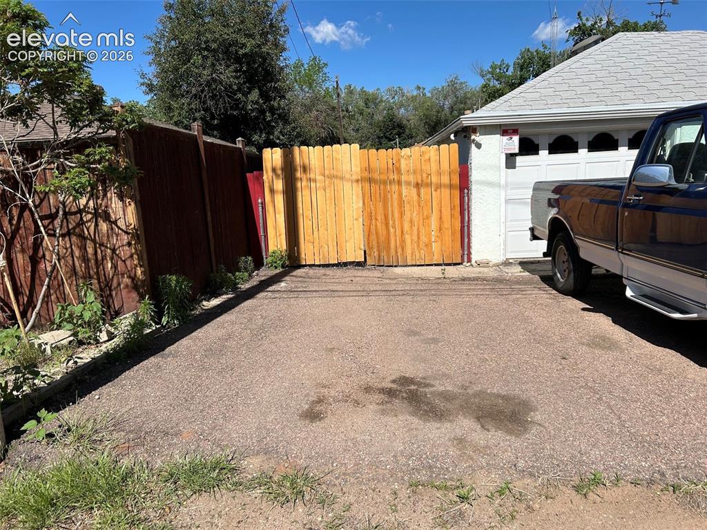 Image 37 of 37: Alley access to 2 car oversized garage w/ fenced rv/boat stoarge. Also room