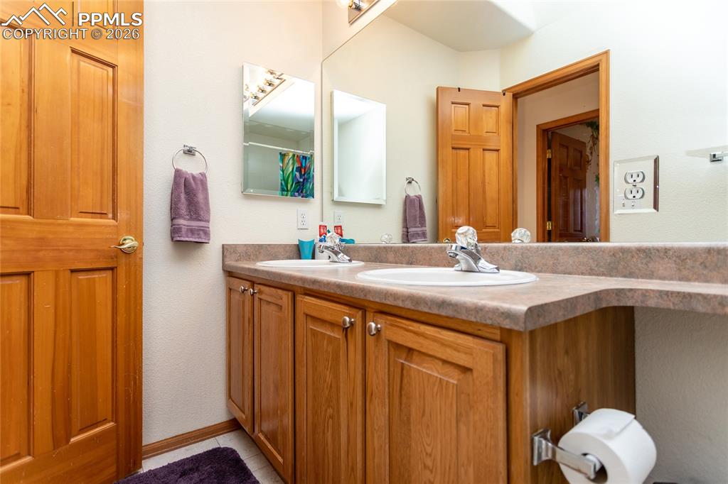 Image 46 of 50: Upper full bathroom with double sinks