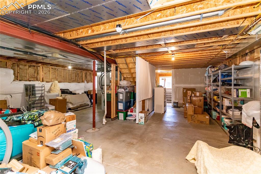 Image 50 of 50: Unfinished basement is waiting to be customized. This window has stairs and