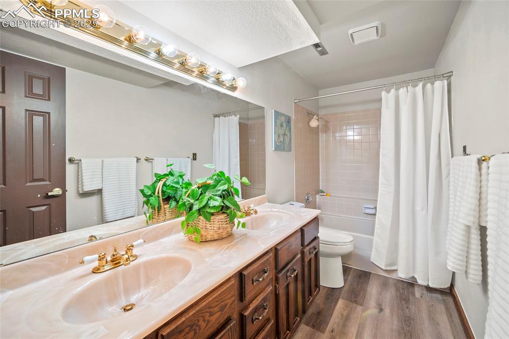 Image 28 of 47: Lower level full bath with double vanity.