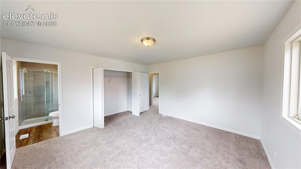 Image 10 of 16: Carpeted flooring with an overhead ceiling light fixture, a window, and a b