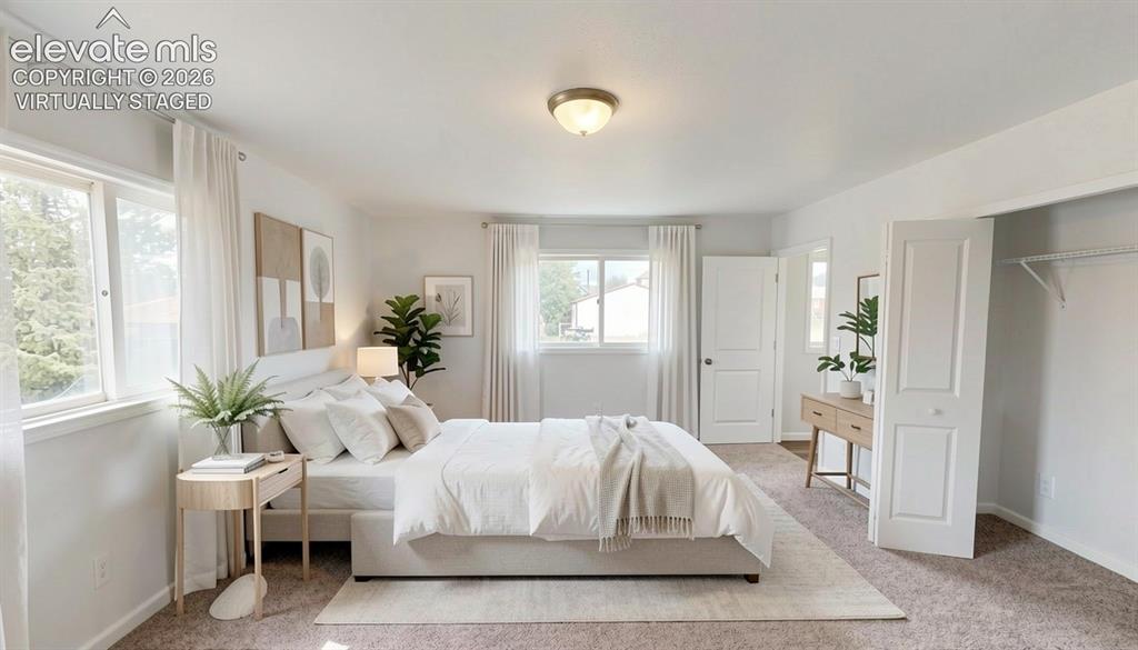 Image 9 of 16: virtually staged.Wall-to-wall carpeting, dual windows with curtains, and a