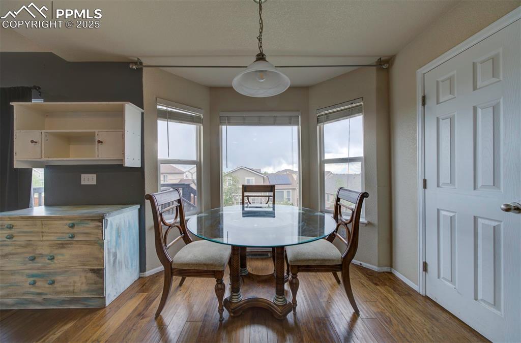 Image 13 of 43: Dining room featuring baseboards, healthy amount of natural light, and wood