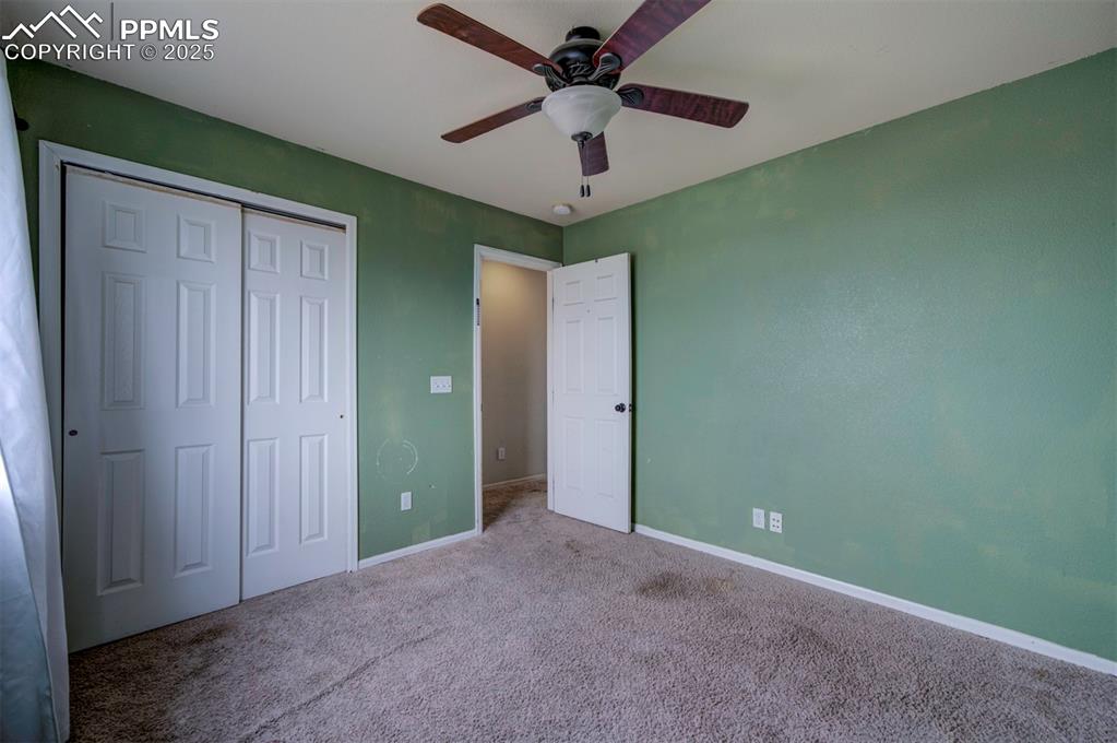 Image 30 of 43: Unfurnished bedroom featuring carpet floors, baseboards, a closet, and ceil
