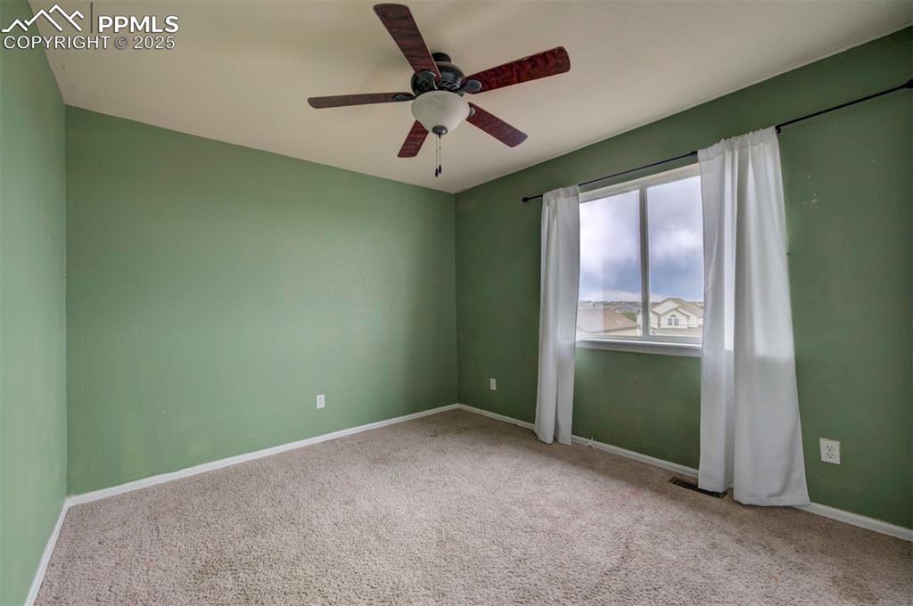 Image 33 of 43: Carpeted empty room featuring a ceiling fan and baseboards
