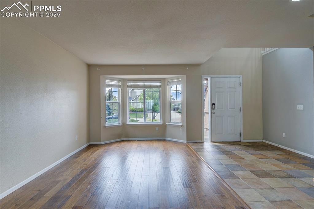 Image 9 of 43: Entryway with baseboards and wood finished floors