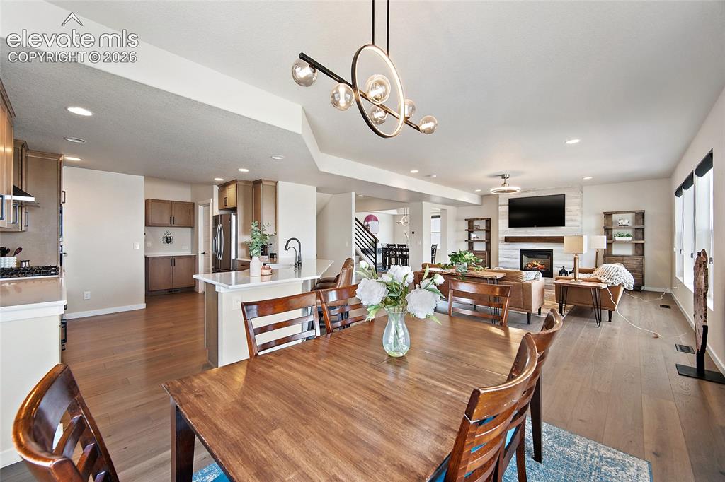 Image 12 of 47: Open-concept living space with wood-finish flooring throughout