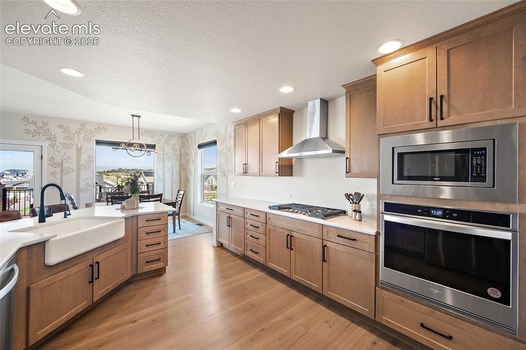 Image 14 of 47: Light wood-finish flooring with recessed lighting