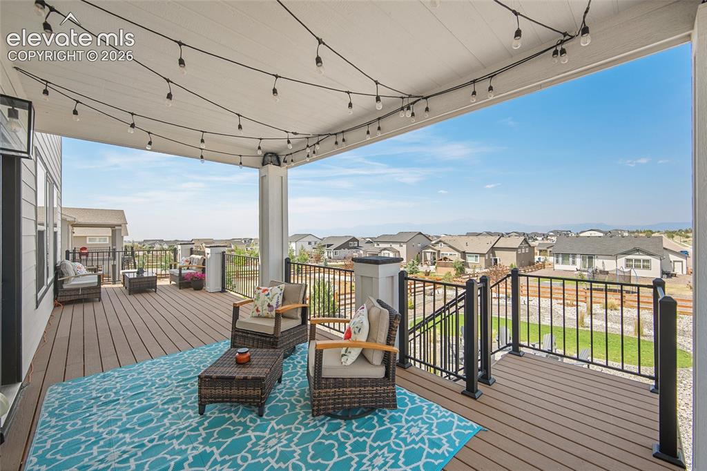 Image 25 of 47: Spacious covered deck featuring composite decking, white ceiling with integ