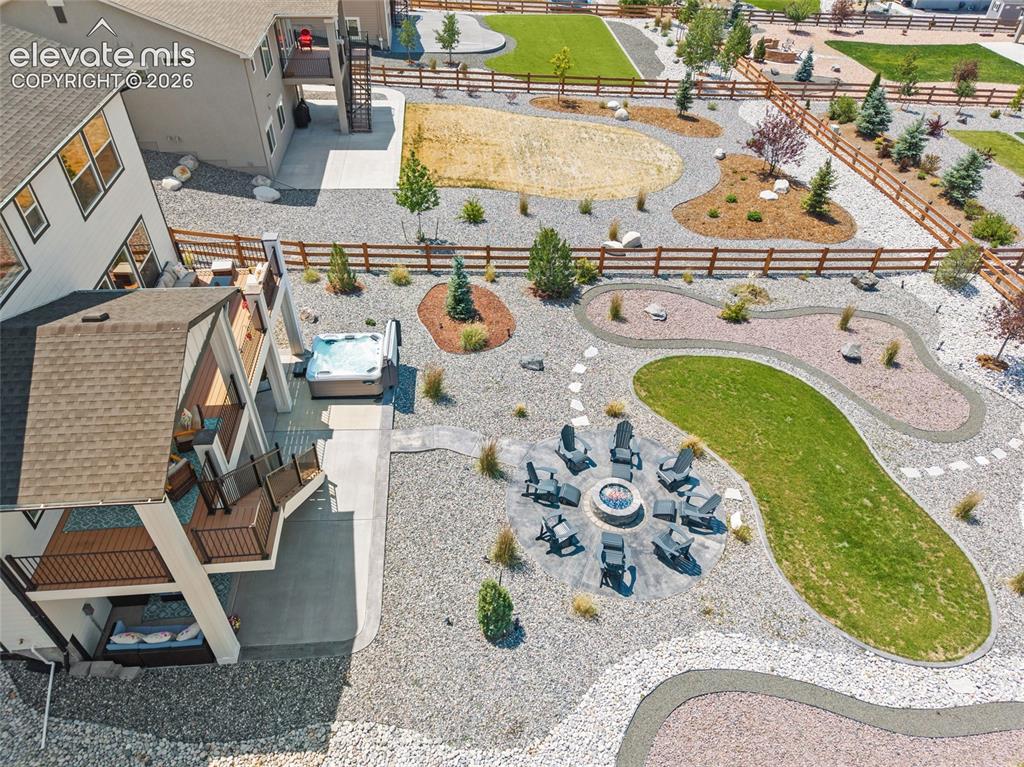 Image 27 of 47: Expansive property featuring a multi-level deck, built-in hot tub, fire pit