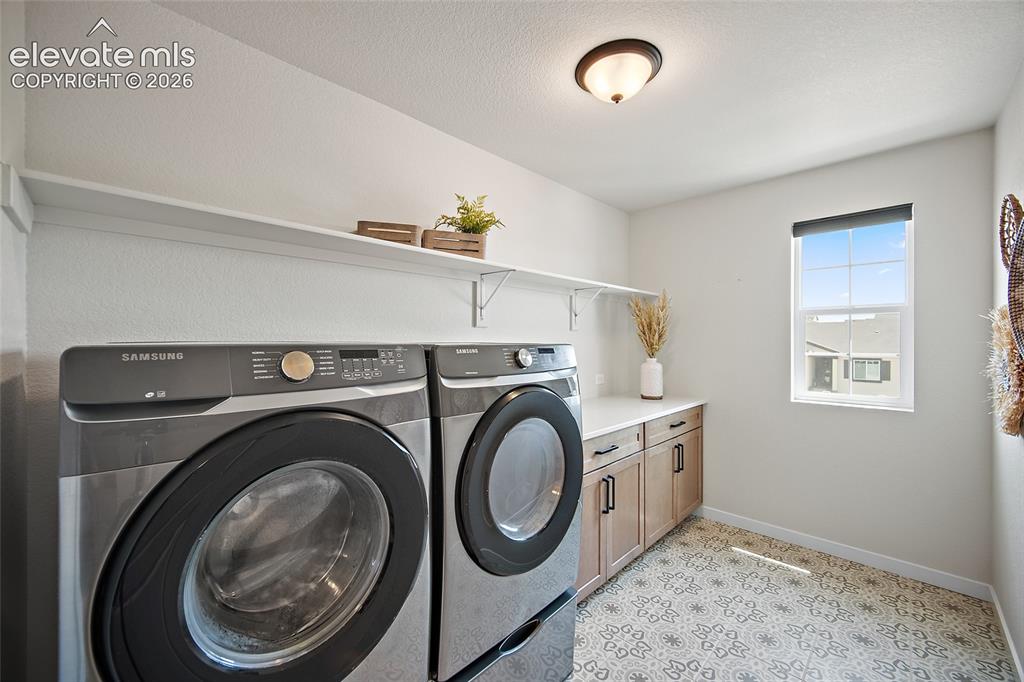 Image 30 of 47: Built-in cabinetry with dark hardware, white countertop, white wall shelvin