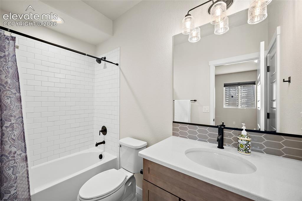 Image 35 of 47: Subway tile shower surround with quartz counters