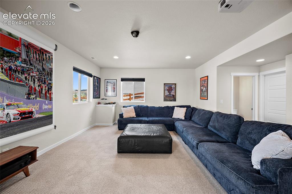 Image 39 of 47: Recessed lighting, large projection screen, wall-mounted projector, multipl