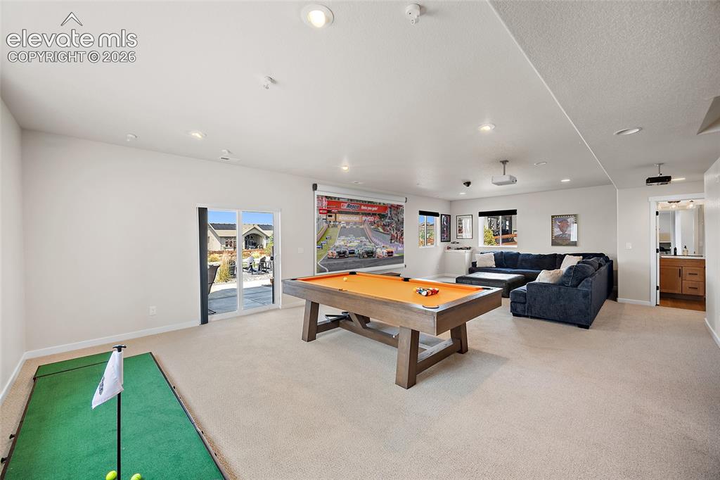 Image 40 of 47: Spacious recreation room featuring recessed lighting, a sliding glass patio