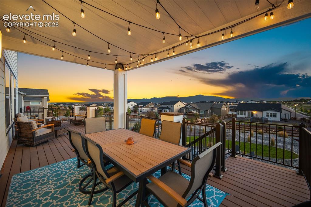 Image 5 of 47: Expansive outdoor covered deck featuring string lighting, composite decking