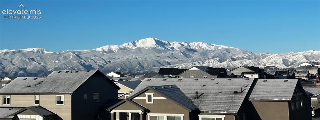 Image 6 of 47: Neighborhood setting with snow-capped mountain backdrop